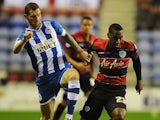 QPR's Junior Hoilett and Wigan's Chris McCann battle for the ball during their Championship match on October 30, 2013