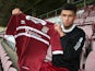 Northampton Town new signing Kane Ferdinand poses with a shirt during a photocall at Sixfields Stadium on October 31, 2013