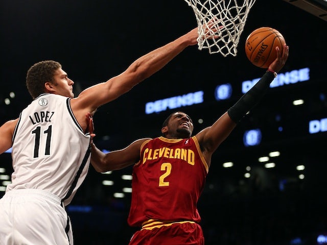 Cleveland Cavaliers guard Kyrie Irving looks to make a shot under pressure from Brooklyn Nets center Brook Lopez on November 13, 2012