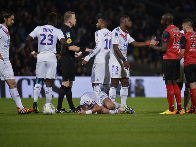 Lyon's French midfielder Maxime Gonalons lies on the ground as he is injured during the French L1 football match Olympique Lyonnais (OL) vs Guingamp (EAG) on November 2, 2013
