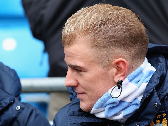 Joe Hart of Manchester City sits on the bench during the Barclays Premier League match between Manchester City and Norwich City at Etihad Stadium on November 2, 2013