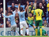 Manchester City's Spanish midfielder David Silva and Manchester City's Argentinian striker Sergio Aguero celebrate their first goal during the English Premier League football match between Manchester City and Norwich City at the Etihad Stadium in Manchest