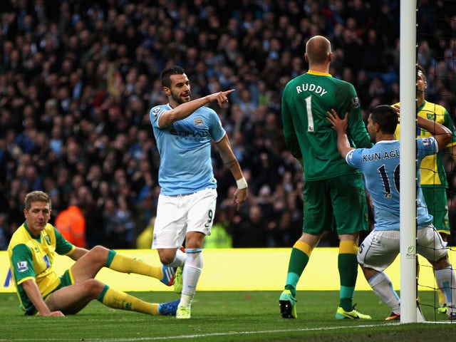 Alvaro Negredo of Manchester City celebrates scoring the fourth goal during the Barclays Premier League match between Manchester City and Norwich City at Etihad Stadium on November 2, 2013