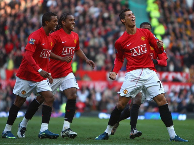 Cristiano Ronaldo of Manchester United celebrates scoring the opening goal with his team mates during the Barclays Premier League match between Manchester United and Hull City at Old Trafford on November 1, 2008
