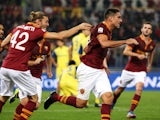 Roma's Marco Borriello celebrates with his teammates after scoring the opening goal during the Serie A match against Chievo Verona on October 31, 2013