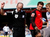 Referee Mike Dean throws down the offending object after being hit by a missile from the crowd during the Coca Cola Championship match between Cardiff City and Swansea on April 5, 2009