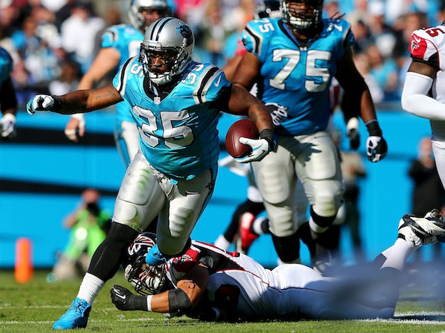 Mike Tolbert of the Carolina Panthers runs with the ball against the Atlanta Falcons during their game at Bank of America Stadium on November 3, 2013