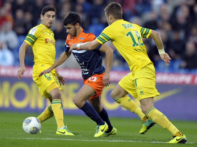 Montpellier's French midfielder Morgan Sanson advances with the ball past Nantes' French midfielders Lucas Deaux and Banel Nicolita during the French L1 football match between Montpellier and Nantes at the Mosson stadium in Montpellier, southe