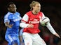 Nicklas Bendtner of Arsenal beats Michael Essien of Chelsea to the ball during the Capital One Cup Fourth Round match on October 29, 2013