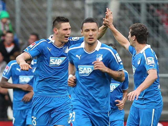 Hoffenheim's Niklas Suele celebrates with teammates after scoring the opening goal against Bayern Munich on November 2, 2013