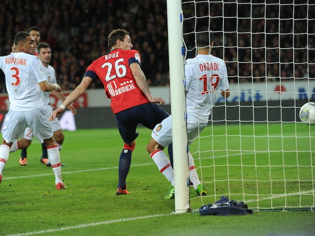 Lille's French forward Nolan Roux scores during their French L1 football match Lille vs Monaco on November 3, 2013