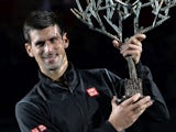 Serbia's Novak Djokovic poses with his trophy after winning the final match of the ninth and final ATP World Tour Masters 1000 indoor tennis tournament on November 3, 2013