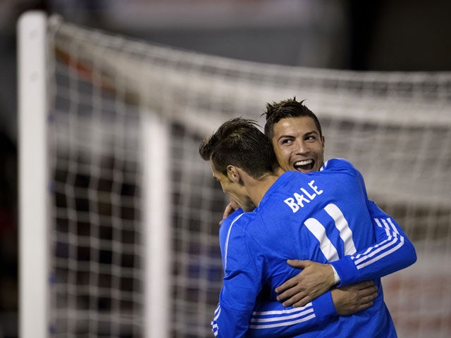 Real Madrid's Portuguese forward Cristiano Ronaldo celebrates with Real Madrid's Welsh striker Gareth Bale after scoring during the Spanish league football match Rayo Vallecano vs Real Madrid at the Vallecas stadium in Madrid on November 2, 2013