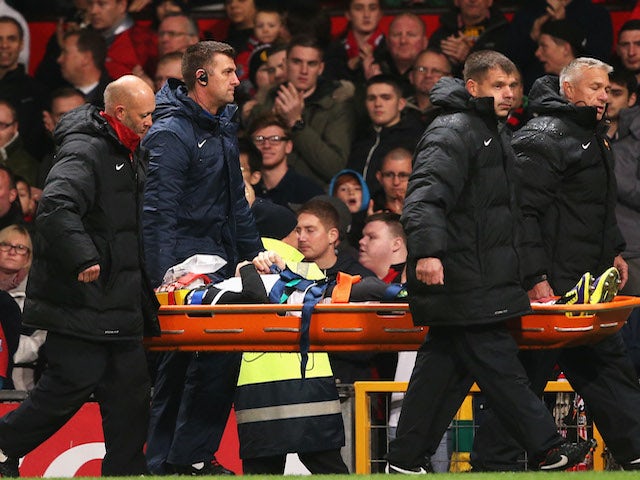 Robert Snodgrass of Norwich City leaves the field on a stretcher during the Capital One Cup fourth round match against Manchester United on October 29, 2013