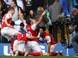 Robin van Persie and his Arsenal teammates celebrate the winning goal against Chelsea in October 29, 2011.