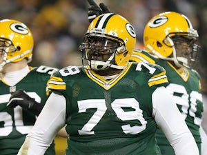 Defensive end Ryan Pickett #79 of the Green Bay Packers reacts in front of teammates inside linebacker A.J. Hawk #50 and nose tackle B.J. Raji #90 in the second quarter against the Minnesota Vikings during the NFC Wild Card Playoff game at Lambeau Field o