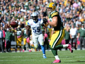 Ryan Taylor #82 of the Green Bay Packers reacts to his dropped pass in front of Stephen Tulloch #55 of the Detroit Lions during the first quarter at Lambeau Field on October 6, 2013