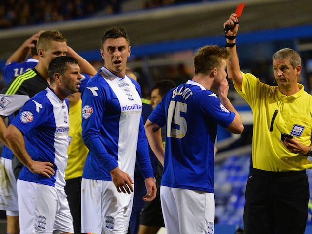 Referee Simon Hooper shows Wade Elliott of Birmingham City a red card during the Capital One Cup Fourth Round match against Stoke City on October 29, 2013