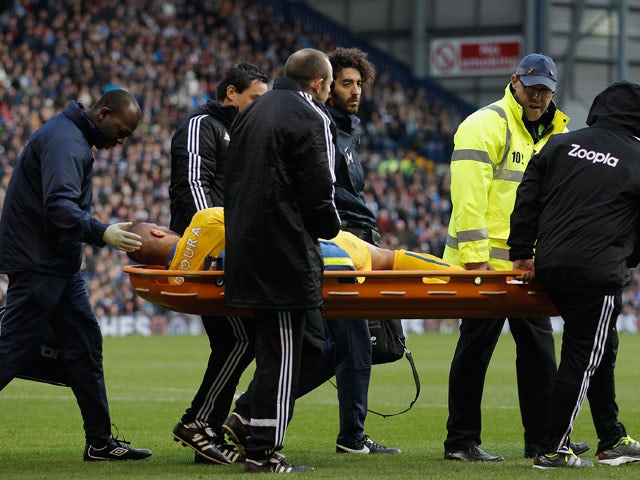 Adlene Guedioura of Crystal Palace is carried off injured during the Barclays Premier League match between West Bromwich Albion and Crystal Palace at The Hawthorns on November 2, 2013