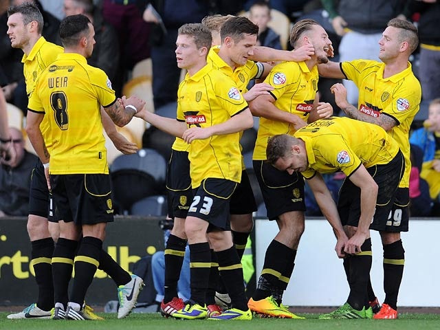Burton's Adam McGurk is congratulated by teammates after scoring the opening goal against Hereford on November 10, 2013