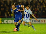 Harry Pell of AFC battles with Carl Baker of Coventry during the FA Cup First Round match between AFC Wimbledon and Coventry City at The Cherry Red Records Stadium on November 8, 2013