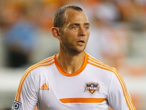 Brad Davis of the Houston Dynamo works out on the field before the game against the Chicago Fire at BBVA Compass Stadium on July 27, 2013