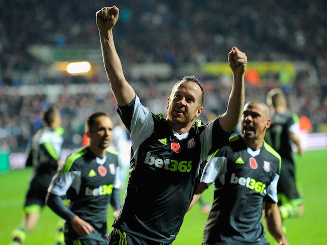 Stoke player Charlie Adam celebrates after scoring from the penalty spot to make the score 3-3 during the Barclays Premier League match against Swansea City on November 10, 2013