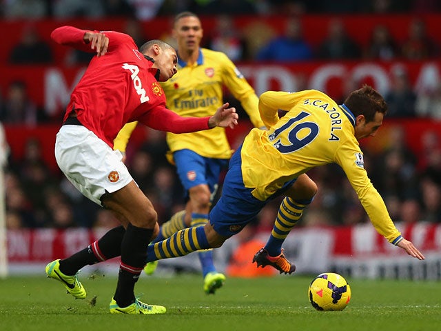 Man United's Chris Smalling and Arsenal's Santi Cazorla battle for the ball on November 10, 2013
