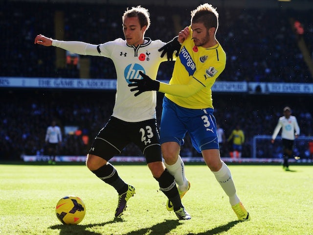 Tottenham Hotspur's Christian Eriksen and Davide Santon of Newcastle United battle for the ball at White Hart Lane on November 10, 2013