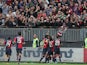 Cagliari's Daniele Conti celebrates with team mates and fans after scoring his second goal against Torino on November 10, 2013