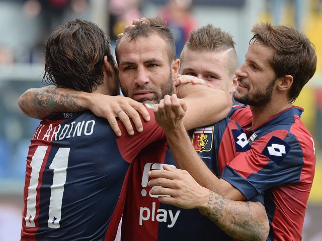 Genoa's Daniele Portanova is congratulated by teammates after scoring the opening goal against Hellas Verona on November 10, 2013