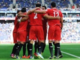 Sevilla's Federico Fazio is congratulated by teammates after scoring the opening goal against Espanyol on November 10, 2013