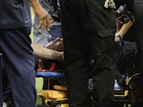Houston Texans head coach Gary Kubiak is loaded on a stretcher after he collapsed on the field as the team left for halftime against the Indianapolis Colts at Reliant Stadium on November 3, 2013