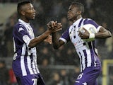 Toulouse midfielder Issiaga Sylla celebrates with teammate after scoring a goal during a French L1 football match against Ajaccio on November 9, 2013