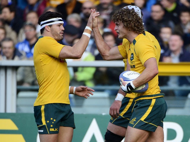 Australias's winger Nick Cummins celebrates his 2nd try during the rugby test match between Italy and Australia on November 9, 2013