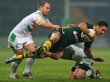 Jarryd Hayne of Australia is tackled by Pat Richards and Liam Finn of Ireland during the Rugby League World Cup Group A match between Australia and Ireland on November 9, 2013