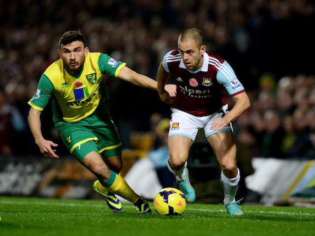Joe Cole of West Ham United takes on Robert Snodgrass of Norwich City during the Barclays Premier League match between Norwich City and West Ham United on November 9, 2013