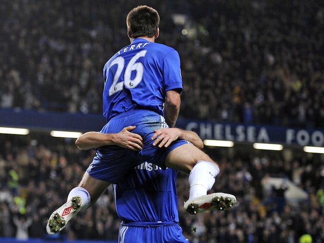 Chelsea's captain John Terry jumps into the arms of team-mate Frank Lampard after scoring during the English Premier League footbal match between Chelsea and Manchester United on November 8, 2009