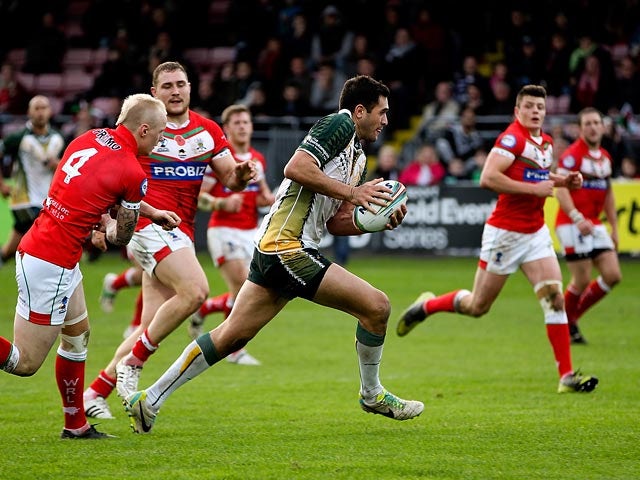 Cook Islands' Jonathon Ford breaks away to score a try against Wales during their World Cup Group D match on November 10, 2013