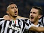 Juventus' midfielder Arturo Vidal of Chile is congratulated by Juventus' defender Leonardo Bonucci after scoring a goal during the UEFA Champions League Group B football match Juventus vs Real Madrid at the Juventus stadium in Turin on November 5, 2013