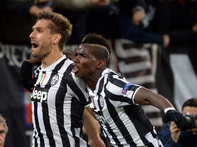 Fernando Llorente of Juventus celebrates his goal with team-mate Paul Pogba during the UEFA Champions League Group B match between Juventus and Real Madrid at Juventus Arena on November 5, 2013