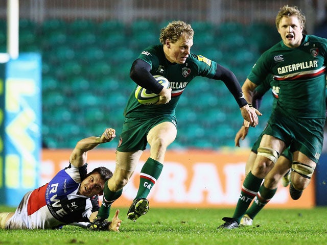 Scott Hamilton of the Leicester Tigers breaks through the tackle of Tom Grabham of the Ospreys during the LV=Cup match between Leicester Tigers and Ospreys at Welford Road on November 8, 2013