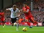 Luis Suarez of Liverpool competes with Elsad Zverotic of Fulham during the Barclays Premier League match between Liverpool and Fulham at Anfield on November 9, 2013