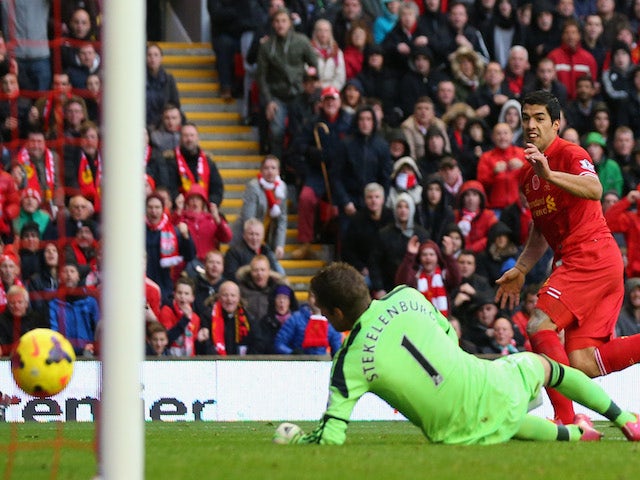 Luis Suarez of Liverpool scores the third goal during the Barclays Premier League match between Liverpool and Fulham at Anfield on November 9, 2013