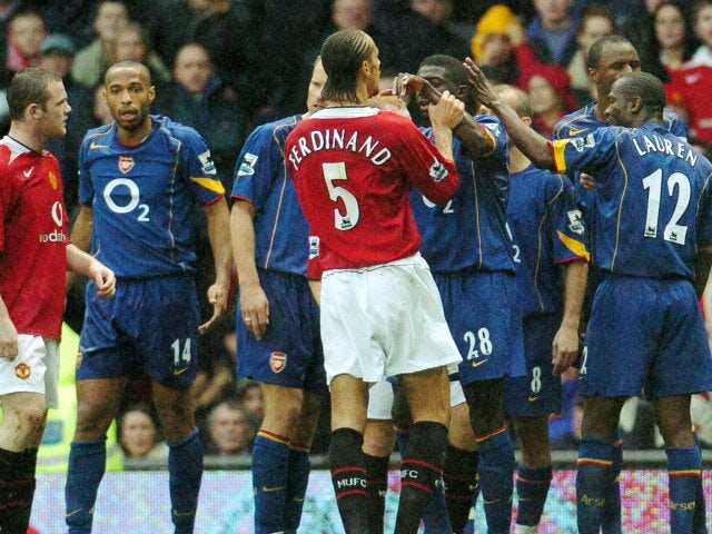 Manchester United and Arsenal players clash during a match at Old Trafford on October 24, 2004.