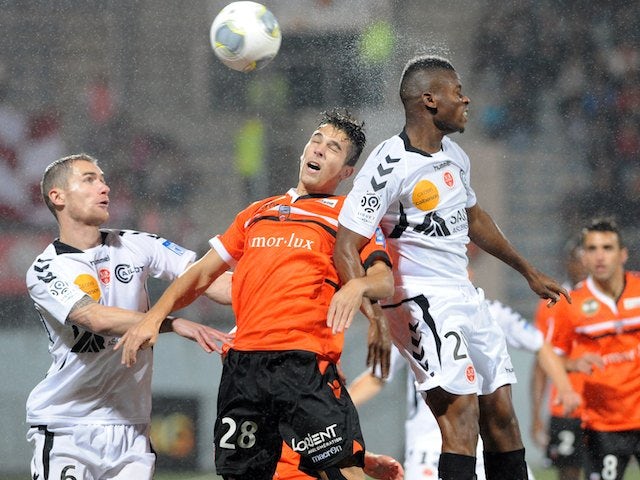 Lorient's midfielder Maxime Barthelme vies with Reims' forward Floyd Ayite and midfielder Antoine Devaux during the French L1 football match 