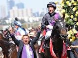 Damien Oliver riding Fiorente after wining the Emirates Melbourne Cup during Melbourne Cup Day at Flemington Racecourse on November 5, 2013