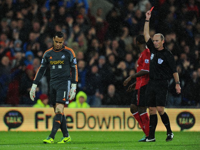 Swansea City goalkeeper Michel Vorm is sent off by referee Mike Dean during the Barclays Premier League match between Cardiff City and Swansea at Cardiff City Stadium on November 3, 2013