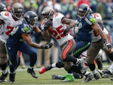 Running back Mike James #25 of the Tampa Bay Buccaneers rushes against middle linebacker Bobby Wagner #54 of the Seattle Seahawks at CenturyLink Field on November 3, 2013