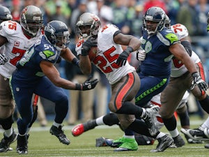 Running back Mike James #25 of the Tampa Bay Buccaneers rushes against middle linebacker Bobby Wagner #54 of the Seattle Seahawks at CenturyLink Field on November 3, 2013